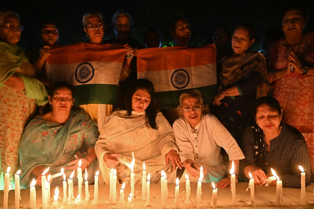 Mourners light candles in Amritsar on April 23, 2025, as they pay tribute to tourists who were shot dead by terrorists in Kashmir's Pahalgam. (Photo by Narinder Nanu / AFP)