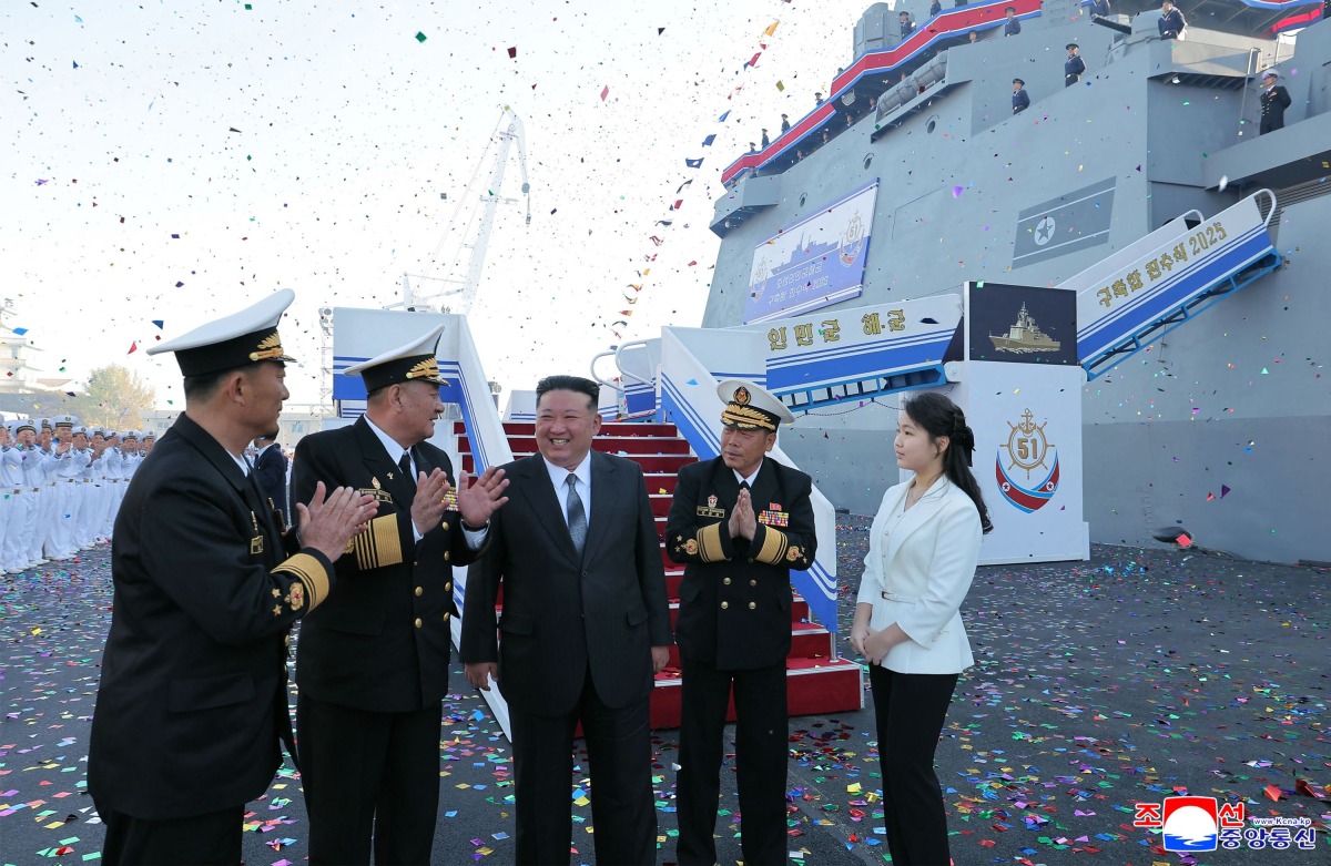 This picture taken on April 25, 2025 and released from North Korea's official Korean Central News Agency (KCNA) on April 26, 2025 shows North Korean leader Kim Jong Un (C) and his daughter Ju Ae (R) attending the launch ceremony of a newly-built destroyer at the Nampo port in Nampo. (Photo by KCNA VIA KNS / AFP)