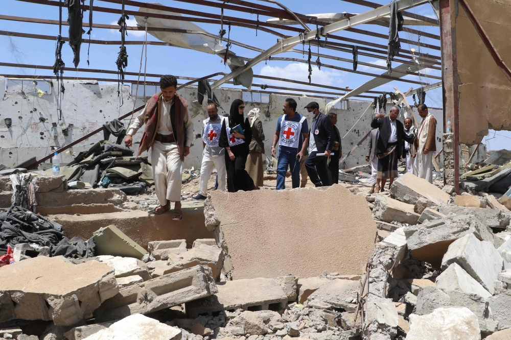 Red Cross members check the rubble of a building hit in US strikes in Yemen's northern province of Saada on April 29, 2025. (Photo by AFP)