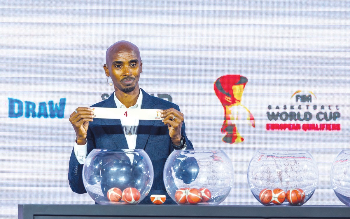 British athlete Mo Farah picks a team during the draw ceremony.