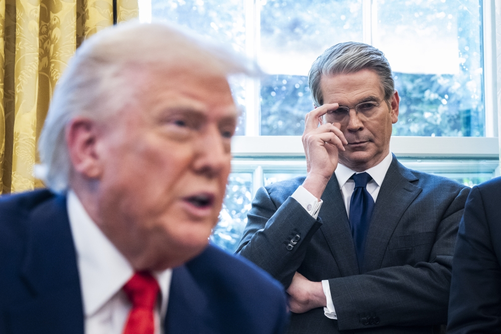 Treasury Secretary Scott Bessent listens as President Donald Trump speaks in the Oval Office at the White House on April 9. (Photo by Jabin Botsford/The Washington Post)
