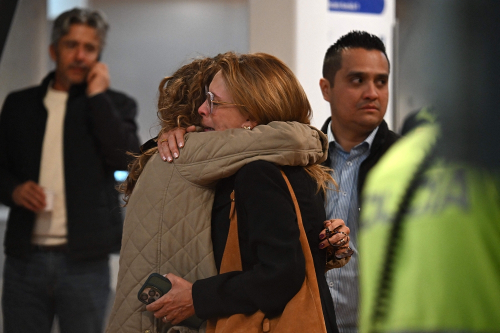 Relatives and friends of Senator Miguel Uribe Turbay wait to receive news about the state of his health on June 8, 2025. (Photo by Raul Arboleda / AFP)