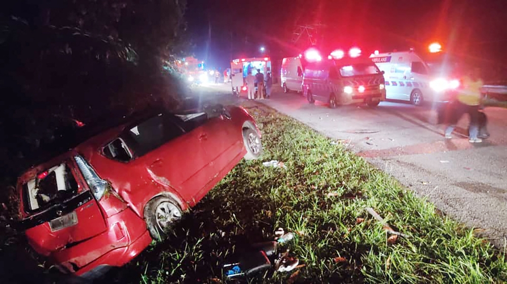 This handout photo taken and released by Perak's Fire and Rescue Department on June 9, 2025 shows a minivan after it collided with a bus in Gerik-Jeli, in Malaysia's Perak state. (Photo by Handout / Perak's Fire and Rescue Department / AFP) 