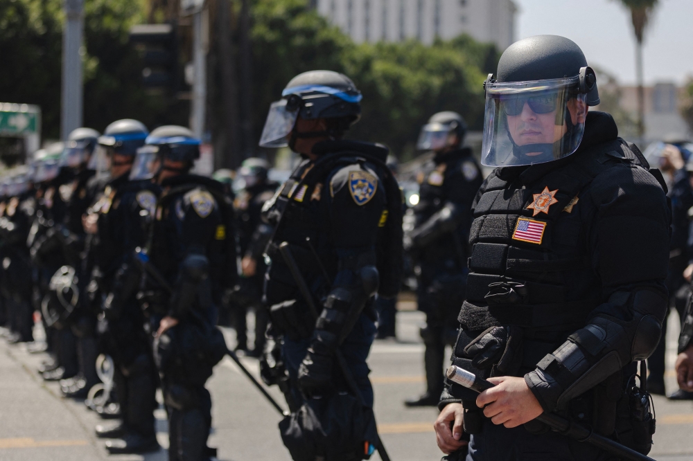 Police officers in riot gear stage outside of the Metropolitan Detention Center on June 9, 2025 in Downtown Los Angeles, California. Jim Vondruska/Getty Images/AFP 