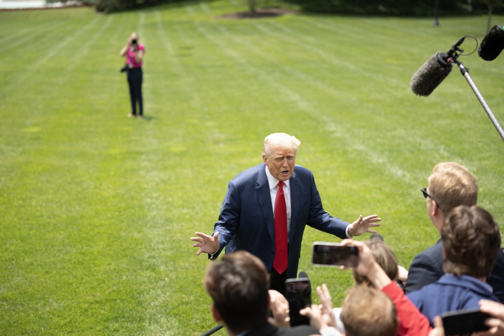 US President Donald Trump speaks to journalists near Marine One on the South Lawn of the White House on Monday. (Photo by Tom Brenner/For The Washington Post)