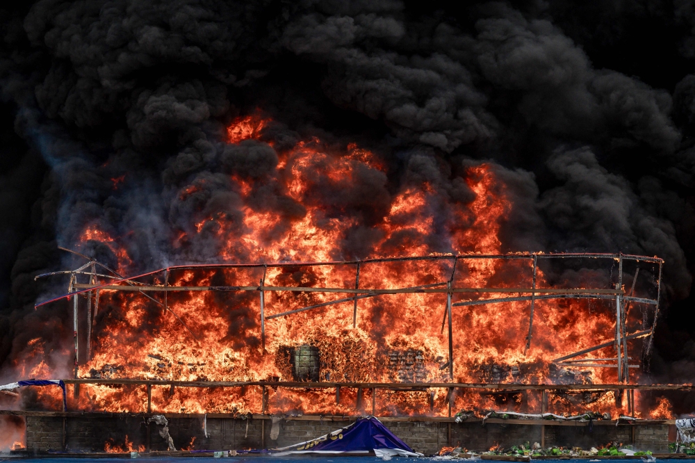 Smoke rises during a destruction ceremony of seized illegal drugs in Yangon on June 26, 2025. (Photo by Sai Aung Main / AFP)