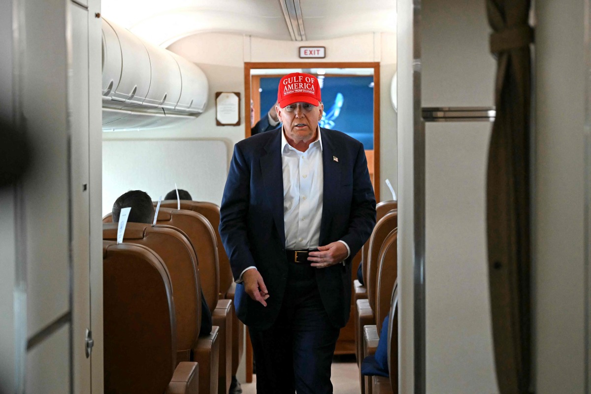 US President Donald Trump walks to speak with the press on board Air Force One as he travels from Ochopee, Florida to Joint Base Andrews, Maryland on July 1, 2025. (Photo by ANDREW CABALLERO-REYNOLDS / AFP)
