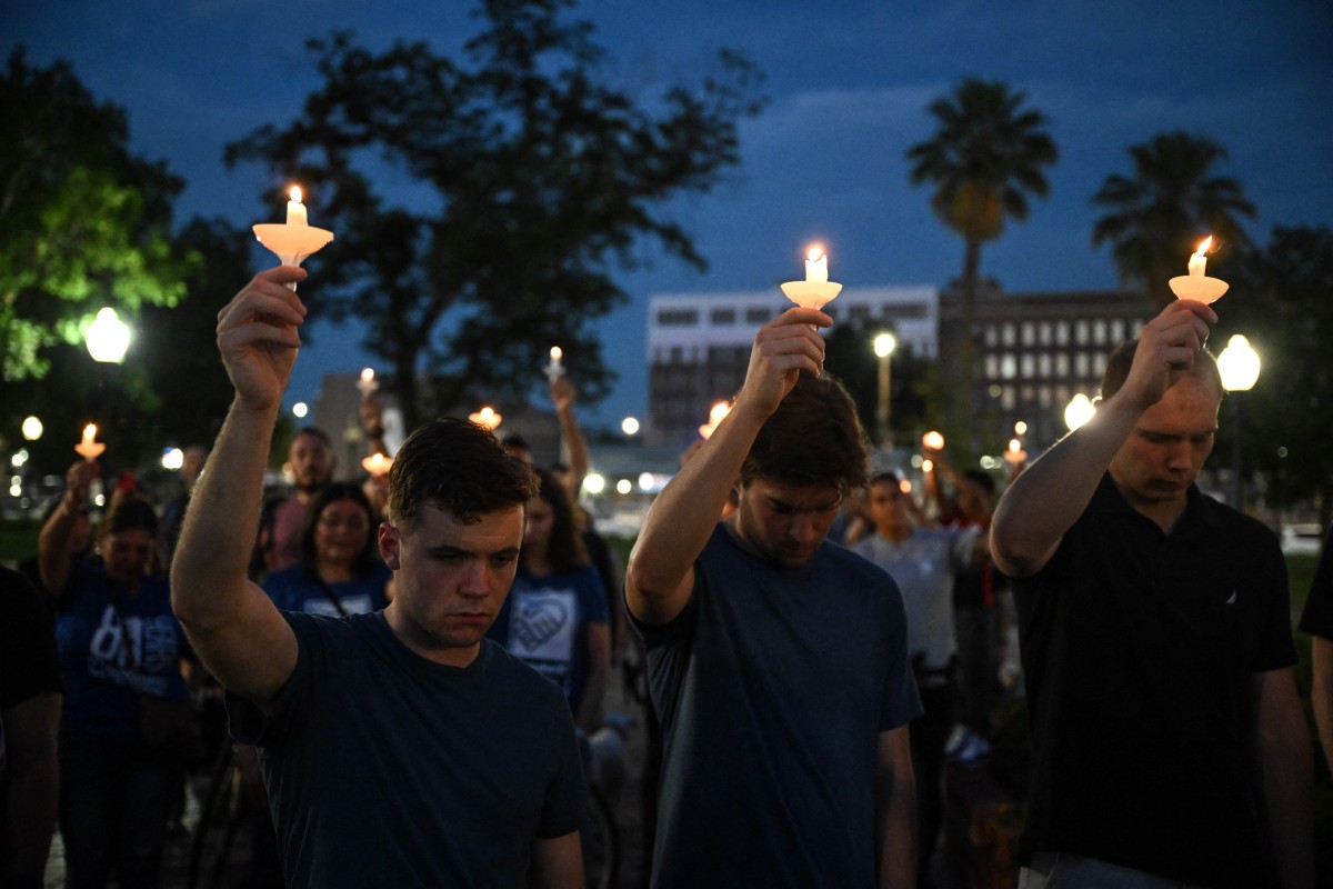 People hold up candles as they take part in a vigil for the victims of the floods over Fourth of July weekend, at Travis Park, in San Antonio, Texas, on July 7, 2025. Photo by Ronaldo Schemidt/ AFP