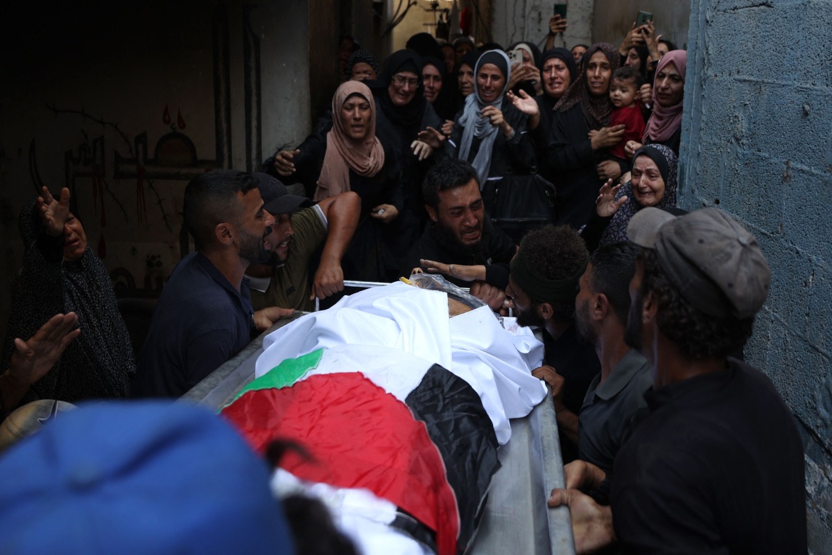 Palestinians mourn a relative, killed the night before in an Israeli strike, during their funeral in Gaza City on July 29, 2025. (Photo by Omar AL-QATTAA / AFP)
