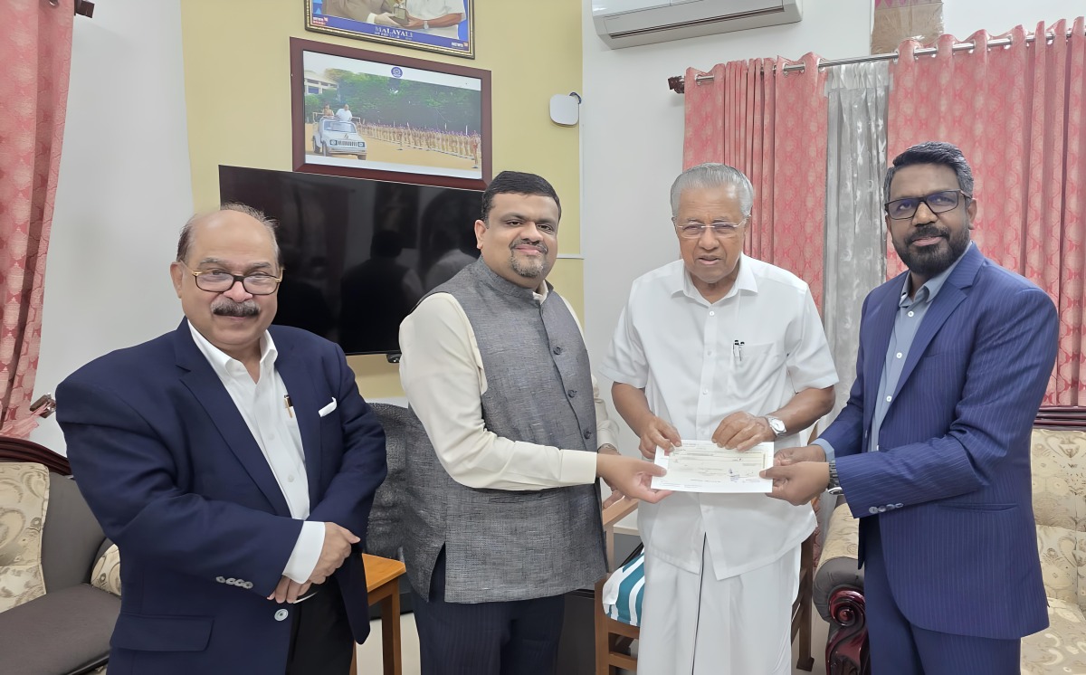 Shanavas Bava, President of ICBF; Thaha Muhammed, President of Indian Business and Professionals Council; and CV Rappai, Director of NORKA presenting the donation to Kerala Chief Minister H E Pinarayi Vijayan.