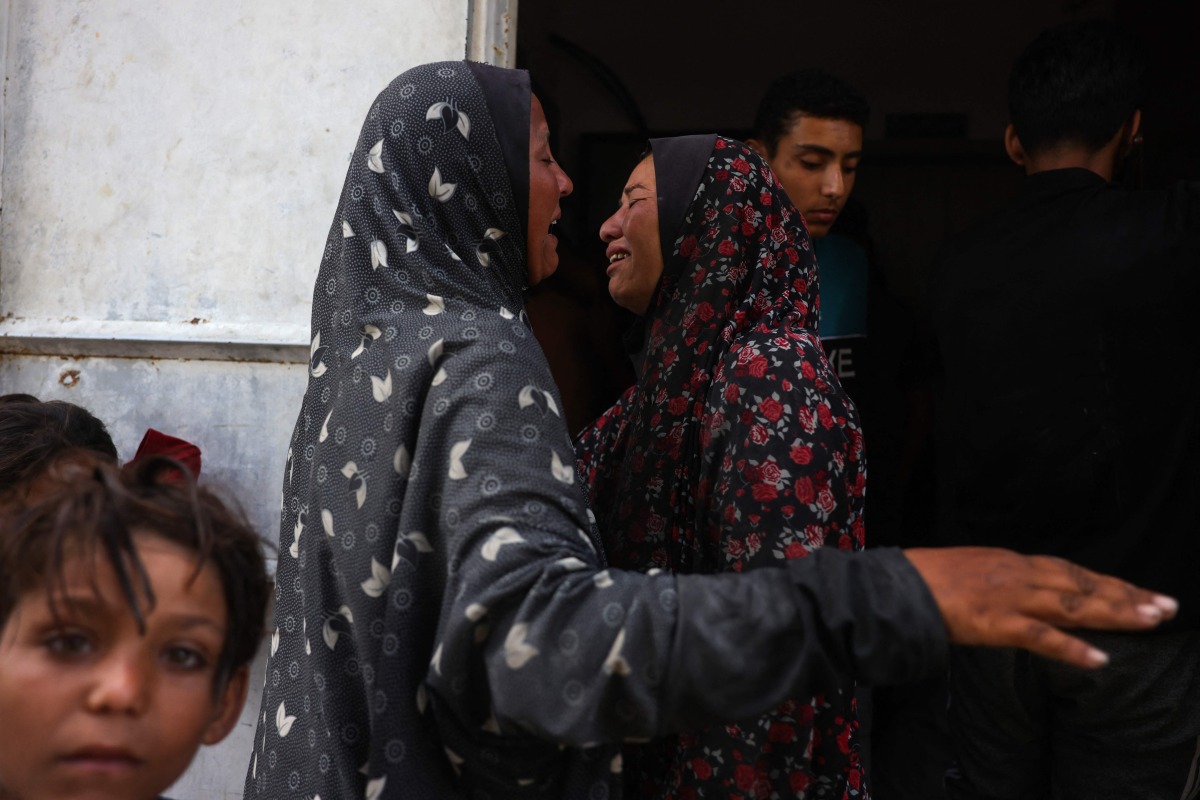 Palestinian women mourn outside the Al-Shifa hospital in Gaza City on July 31, 2025, where bodies of people killed a day earlier while waiting for aid were brought. (Photo by Bashar TALEB / AFP)
