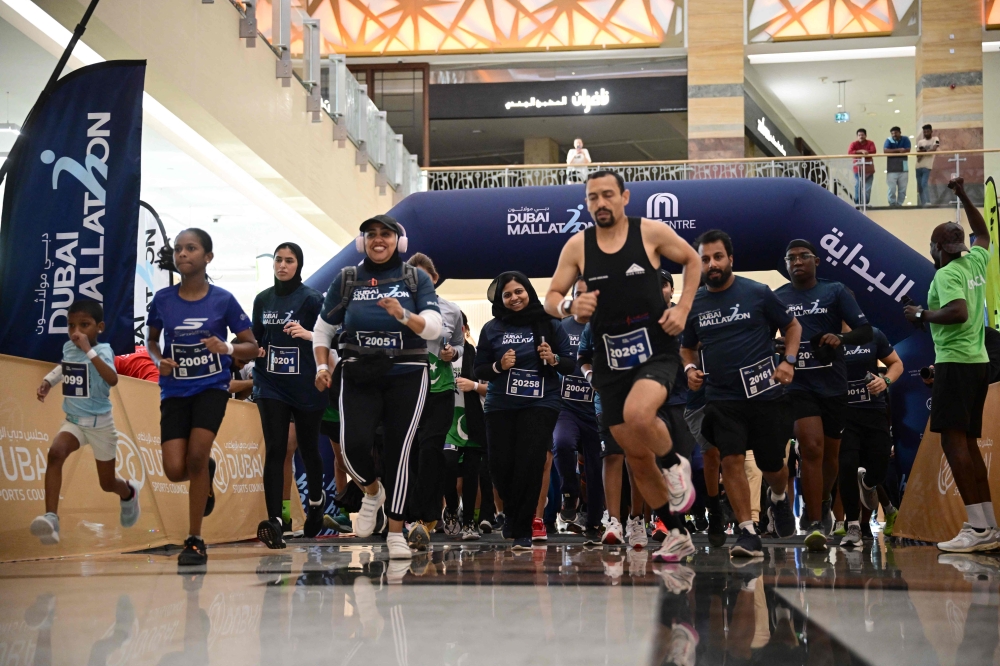 People take part in Dubai Mallathon 2025, at the City Centre Mirdif mall in Dubai on August 9, 2025. (Photo by Giuseppe Cacace / AFP)