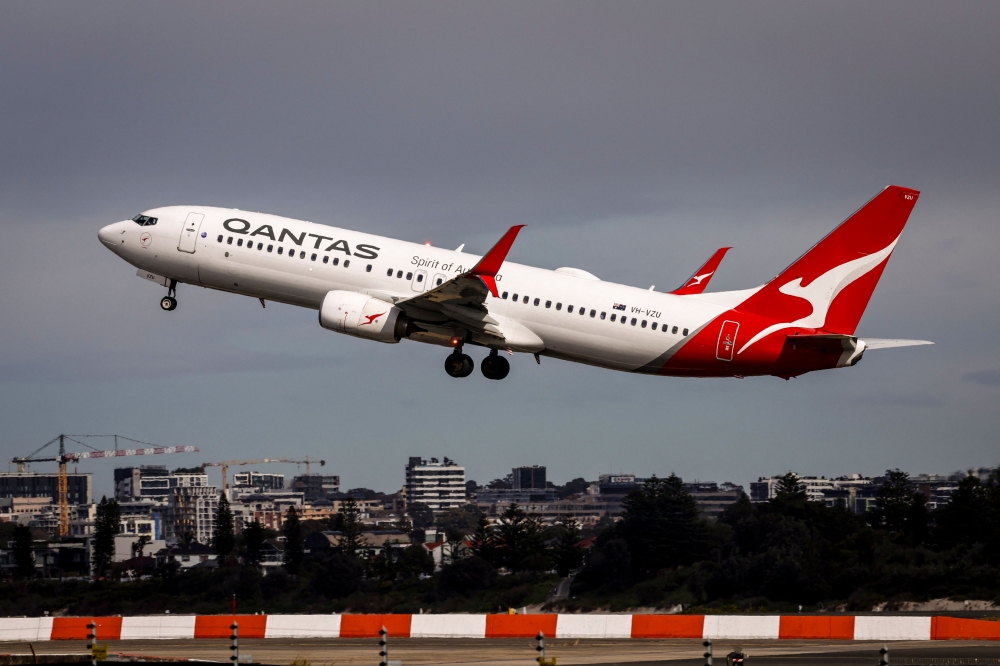 A Qantas Airways Boeing 737 aircraft takes off from Sydney International Airport in Sydney on August 18, 2025. (Photo by David Gray / AFP)