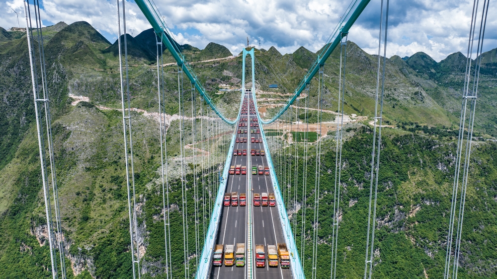 This aerial drone photo taken on August 25, 2025 shows a load test on the Huajiang Grand Canyon Bridge, set to become the world's tallest bridge, in southwest China's Guizhou Province. (Xinhua/Tao Liang)