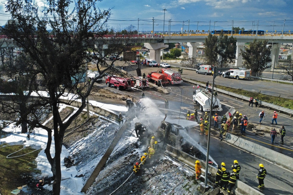 Mexican firefighters extinguish the flames of a gas truck that exploded in Mexico City on September 10, 2025. (Photo by Valentina Alpide / AFP)