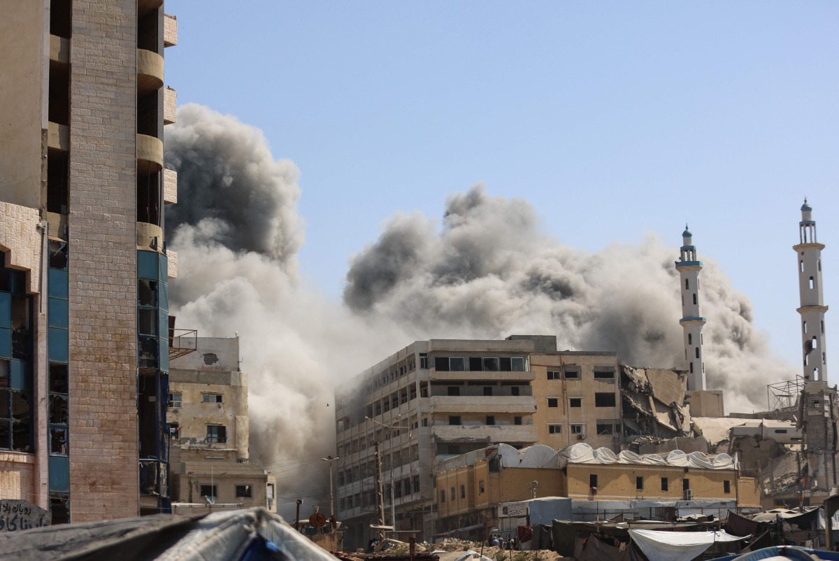 Smoke billows as Israeli airstrikes destroy the al-Ghafari tower in Gaza City on September 15, 2025. Photo by Omar AL-QATTAA / AFP