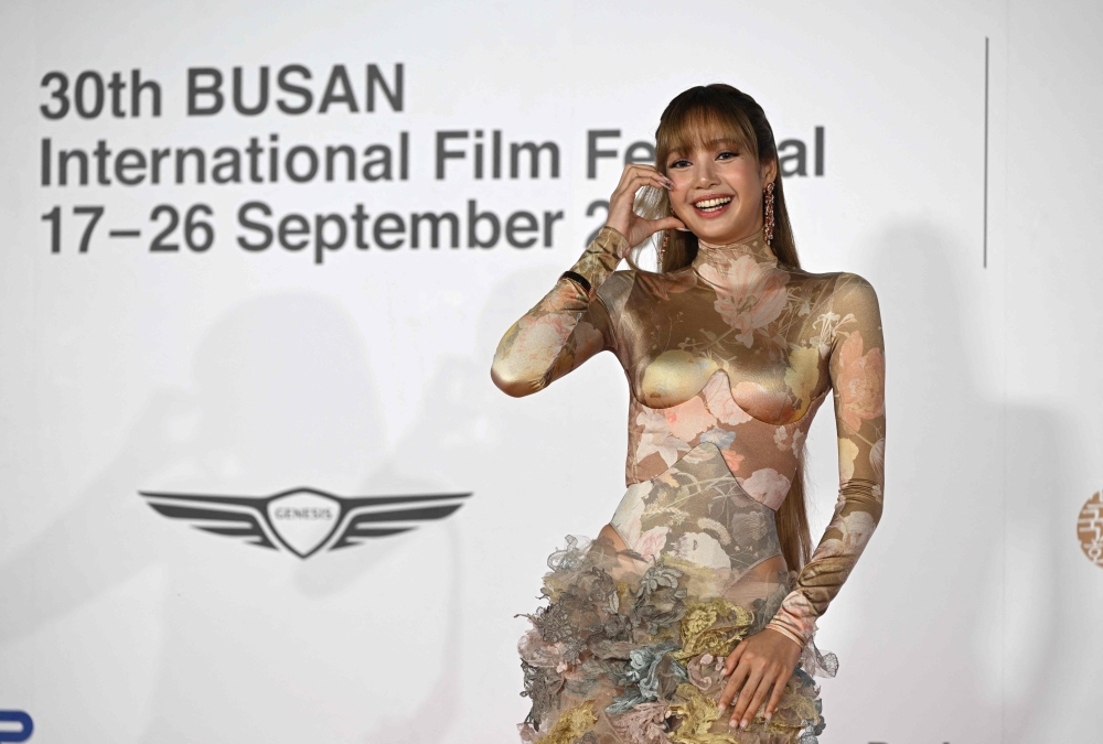 Lisa, a member of the K-pop group Blackpink, arrives on the red carpet during the opening ceremony of the 30th Busan International Film Festival (BIFF) at the Busan Cinema Center in Busan on September 17, 2025. (Photo by Jung Yeon-je / AFP)