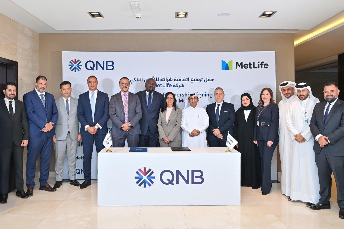 QNB and MetLife officials pose for a group photo during the signing of agreement.
