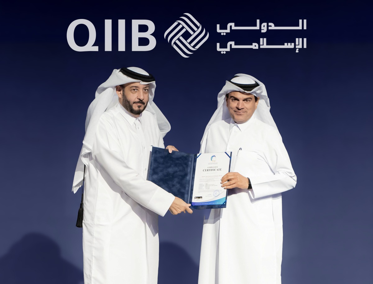 NCSA President Eng. Abdul Rahman Ali Muhammad Al-Farahid Al-Malki presenting the NIA certification to QIIB Chief Executive Officer, Dr. Abdulbasit Ahmad al-Shaibei.