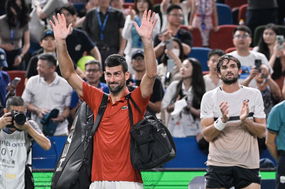Serbia's Novak Djokovic acknowledges spectators after losing in his men's singles semi-final match against Monaco's Valentin Vacherot on October 11, 2025. (Photo by Hector Retamal / AFP)