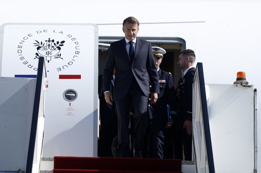 France's President Emmanuel Macron arrives for the Gaza Summit in Sharm El-Sheikh, Egypt on October 13, 2025. (Photo by Yoan Valat / POOL / AFP)