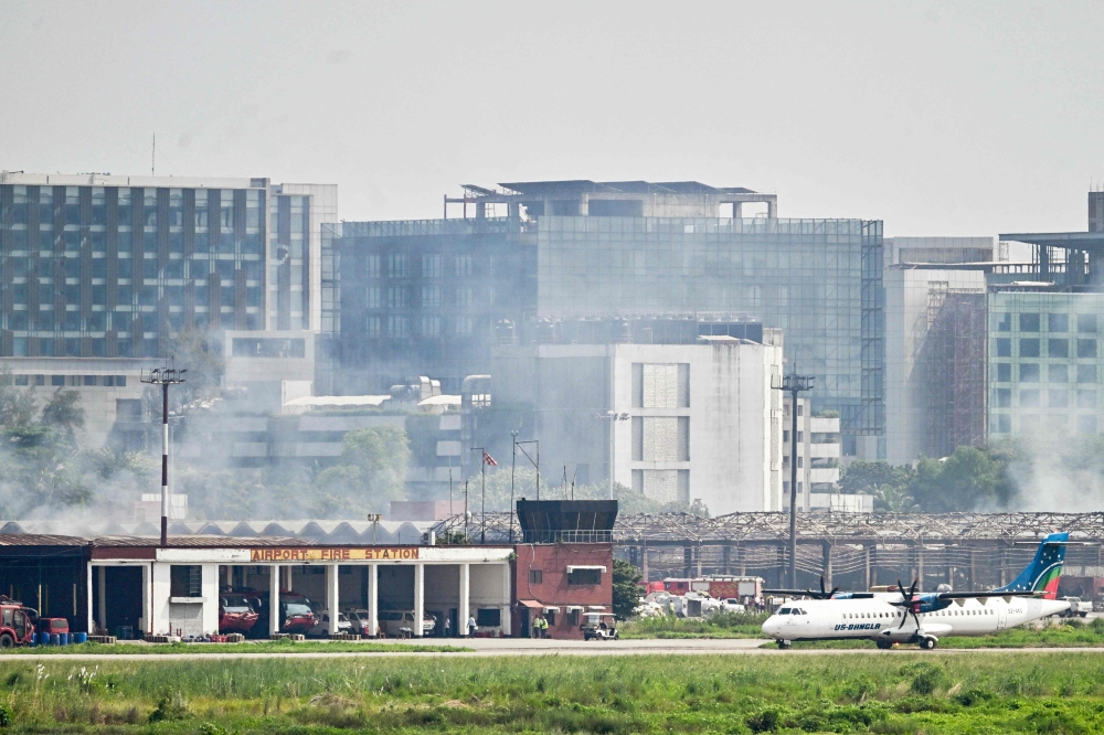 Bangladesh firefighters douse fire at the cargo terminal on October 19, 2025. Photo by Munir Uz Zaman / AFP