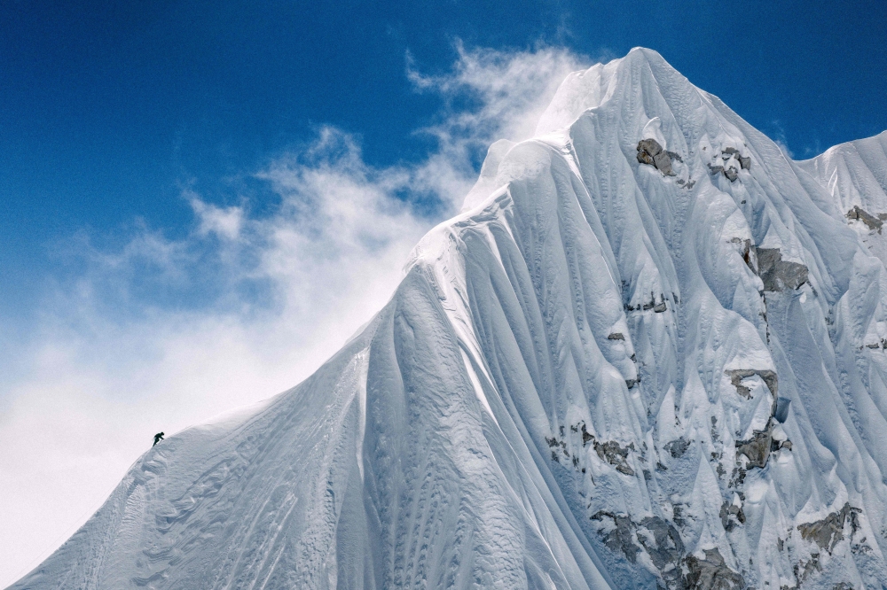 In this handout photograph taken on October 15, 2025, a French mountaineer makes his way near the summit of Jannu East, the first ascent of the 7,468 m peak in eastern Nepal. (Photo by Thibaut Marot / AFP)