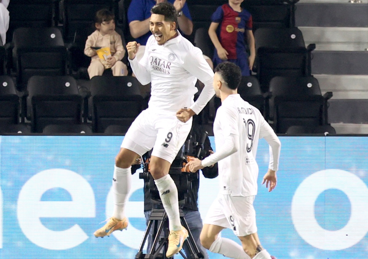 Al Sadd's Roberto Firmino (left) celebrates with teammate Rafa Mujica after scoring a goal against Al Rayyan yesterday. 