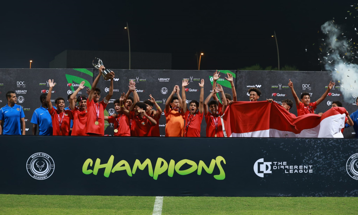 Players and officials of Right To Dream celebrate with the trophy.