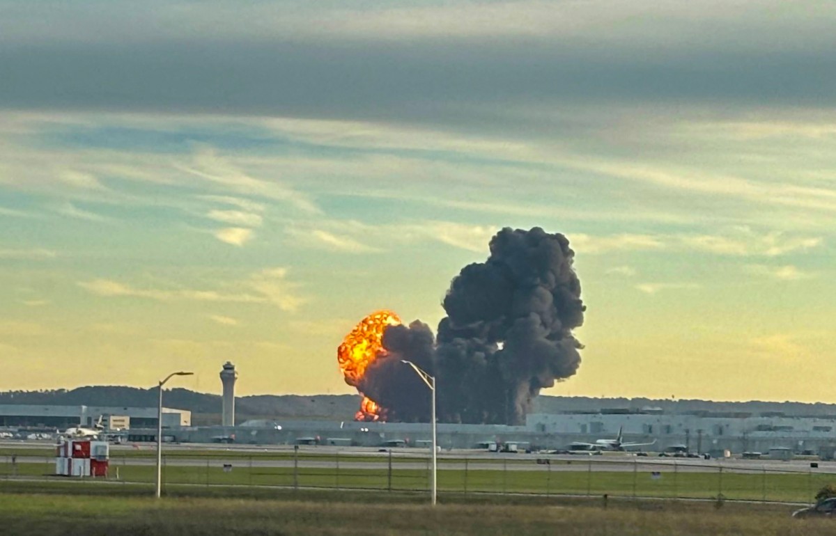 This handout photo courtesy of Levi Dean shows smoke and flames rising from the site of a UPS cargo plane crash outside Louisville International Airport in Louisville, Kentucky, on November 4, 2025. Handout / Courtesy of X Account @LEVIDEAN98 / AFP