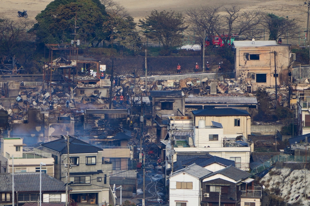 Smouldering buildings are seen following an overnight fire at a residential area near the Saganoseki Fishing Port in Oita City on November 19, 2025.  (Photo by Jiji Press / AFP)