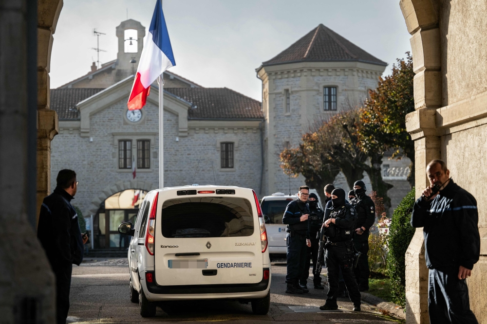 A Gendarmerie car drives past the entrance of the jail of Dijon, eastern France on November 27, 2025. (Photo by Arnaud Finistre / AFP)
