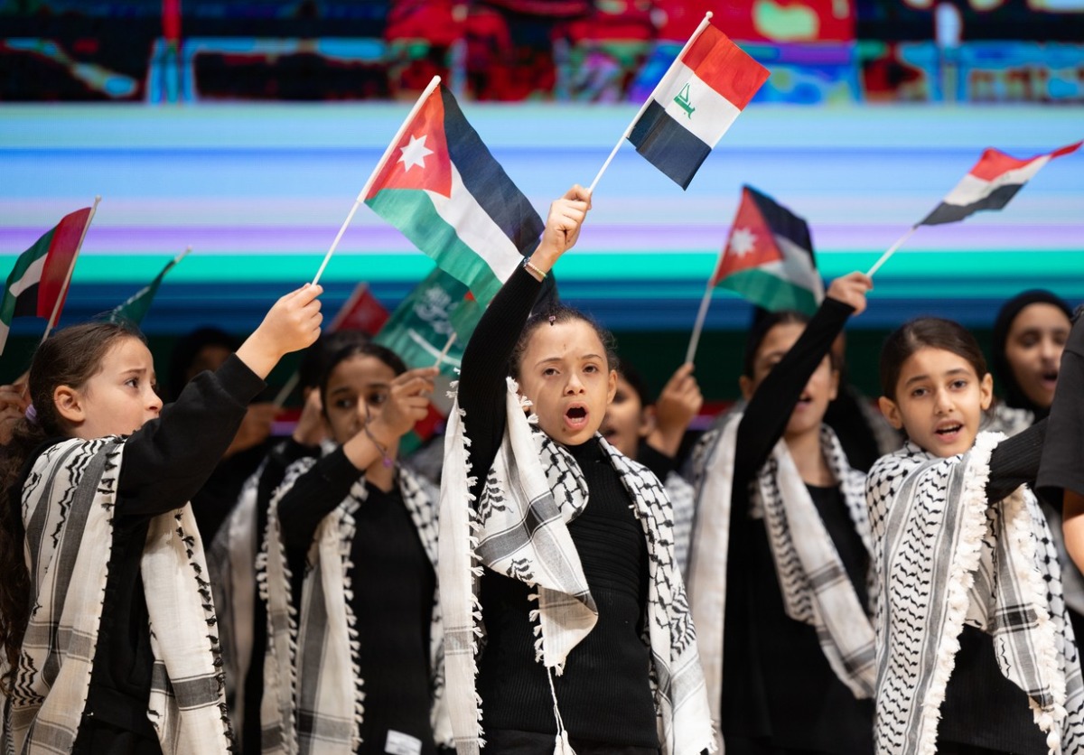 Children wave Arab flags during the event marking International Day of Solidarity with the Palestinian People.