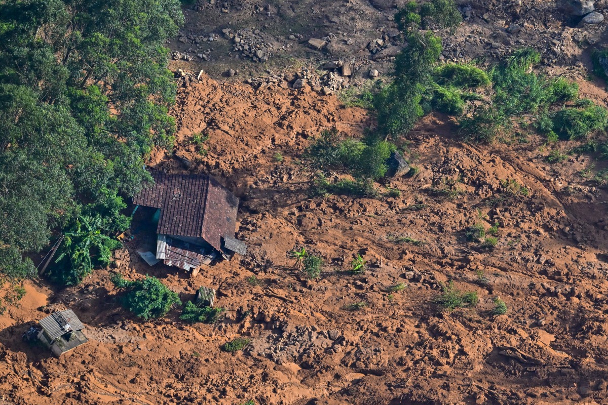 An aerial view shows a residential house lying in a shattered state at the site of a landslide in Nuwara Eliya on December 2, 2025. Photo by ISHARA S. KODIKARA / AFP