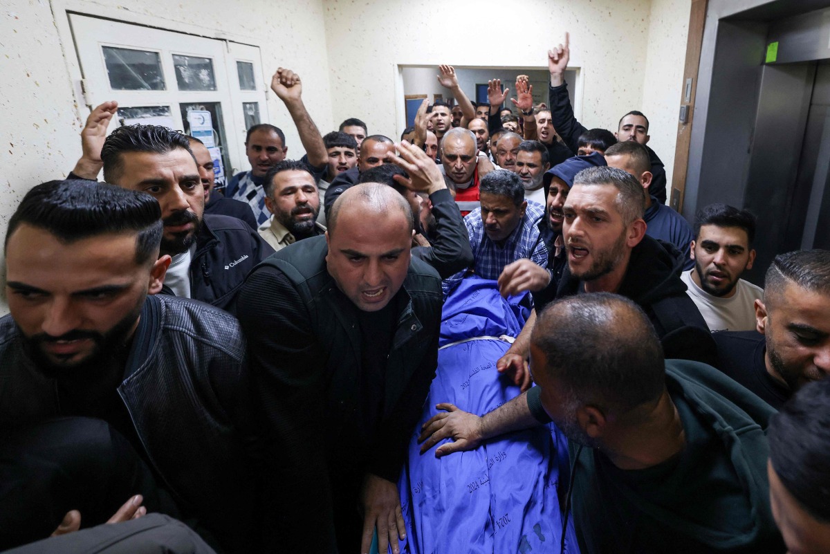 Palestinians mourn over the body of Bahaa Rashed at Rafidia hospital in Nablus after he was killed during an operation by Israeli forces in the village of Odala, south of Nablus in the occupied West Bank, on December 5, 2025. (Photo by JAAFAR ASHTIYEH / AFP)