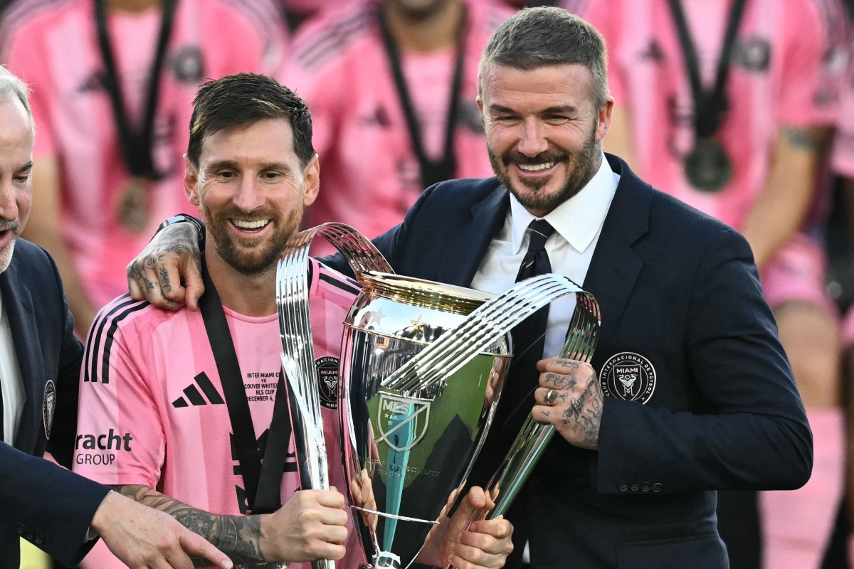 File photo of Inter Miami's Argentine forward #10 Lionel Messi (L) poses with the trophy next to the team's owner David Beckham (R) after winning the Major League Soccer (MLS) Cup final between Inter Miami and the Vancouver Whitecaps at Chase Stadium in Fort Lauderdale, Florida, on December 6, 2025.