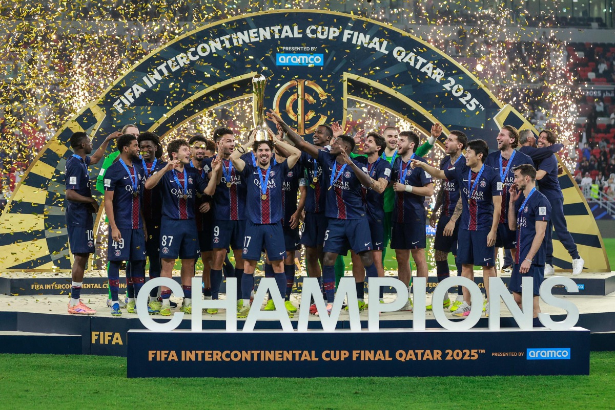 PSG's players celebrate with the trophy after winning the 2025 FIFA Intercontinental Cup final football match between Paris Saint-Germain (PSG) and CR Flamengo at the Ahmad bin Ali Stadium in Al-Rayyan on the outskirts of Doha on December 17, 2025. (Photo by Karim JAAFAR / AFP)