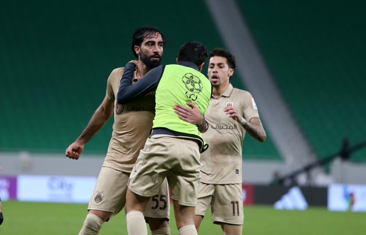 Al Rayyan's Mohammed Saleh (left) celebrates with teammates after scoring the late equaliser.