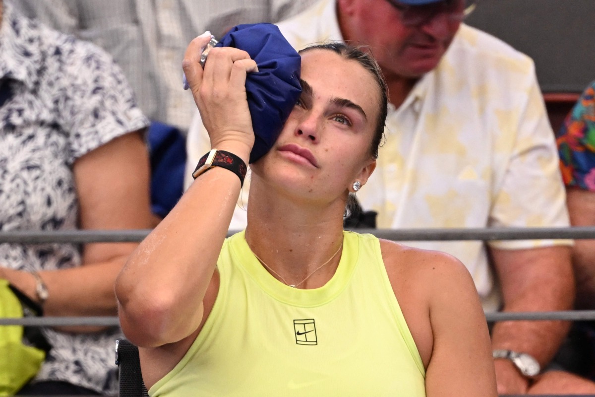 Aryna Sabalenka of Belarus places an ice pack on her head during her women's singles match against Sorana Cirstea of Romania at the Brisbane International tennis tournament in Brisbane on January 8, 2026. (Photo by William WEST / AFP)