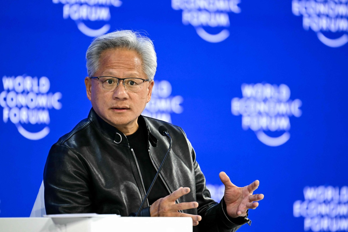 Nvidia founder and CEO Jensen Huang gestures as he speaks during the World Economic Forum (WEF) annual meeting in Davos on January 21, 2026. Photo by Fabrice COFFRINI / AFP