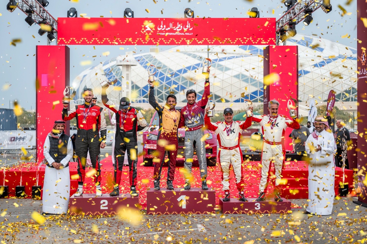 The top three teams celebrate on the podium in presence of Qatar Motor & Motorcycle Federation (QMMF) and Lusail International Circuit President Abdulrahman bin Abdullatif Al Mannai and QMMF CEO Amro Al Hamad.