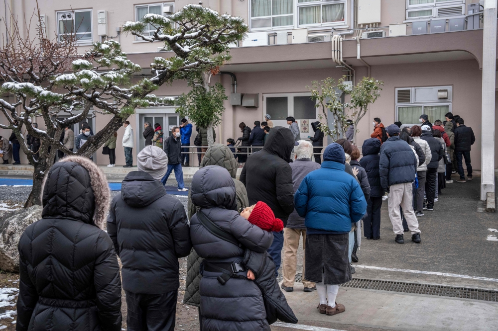 People queue up at a polling station to vote during the House of Representatives election in Kawasaki, Kanagawa prefecture on February 8, 2026. (Photo by Yuichi Yamazaki / AFP)