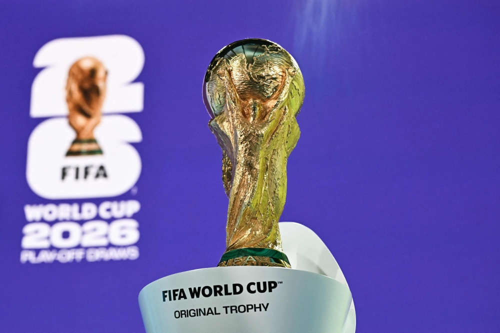 (Files) This photograph shows the 2026 FIFA World Cup trophy following the 2026 FIFA World Cup European Play-Off draw at the FIFA's Home of Football in Zurich on November 20, 2025.(Photo by Fabrice Coffrini / AFP)