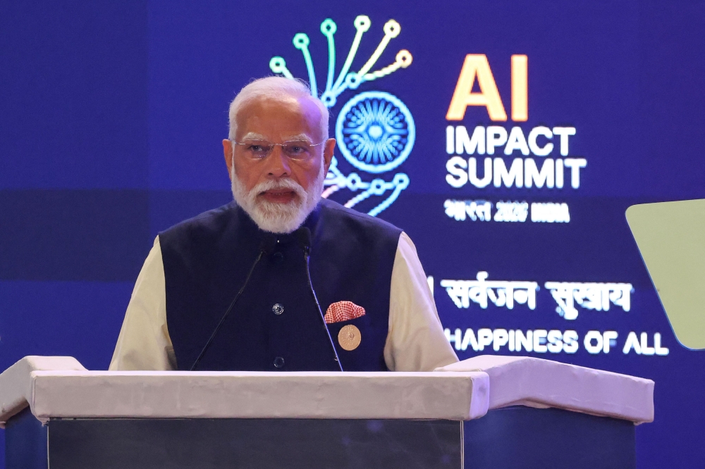 India's Prime Minister Narendra Modi delivers a speech at the AI Impact Summit in New Delhi on February 19, 2026. (Photo by Ludovic Marin / AFP)
