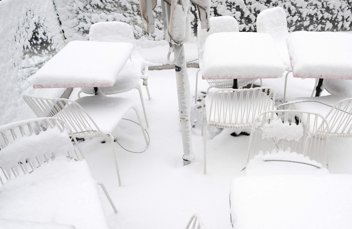 Snow covers chairs and tables of a cafe as winter strikes Vienna, Austria with snow and freezing temperatures on February 20, 2026. (Photo by Joe Klamar / AFP)