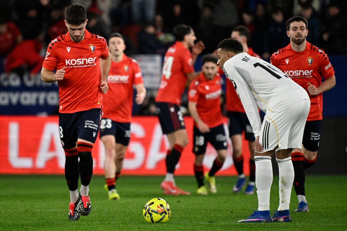 Real Madrid's French forward #10 Kylian Mbappe reacts to Osasuna's second goal scored by Spanish forward #09 Raul Garcia during the Spanish league football match between CA Osasuna and Real Madrid CF at El Sadar Stadium in Pamplona on February 21, 2026. (Photo by ANDER GILLENEA / AFP)