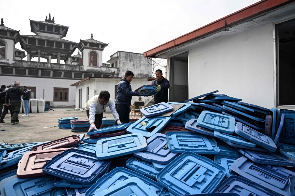 (Files) Election officials inspect ballot boxes before they are dispatched from the Election Commission office in Kathmandu on February 9, 2026 ahead of Nepal's general elections. (Photo by Prakash MATHEMA / AFP)