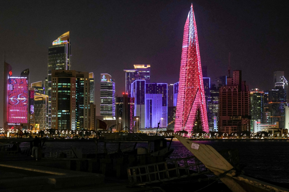 High-rise buildings are pictured at night along the Corniche in Doha on March 1, 2026. (Photo by Karim Jaafar / AFP)