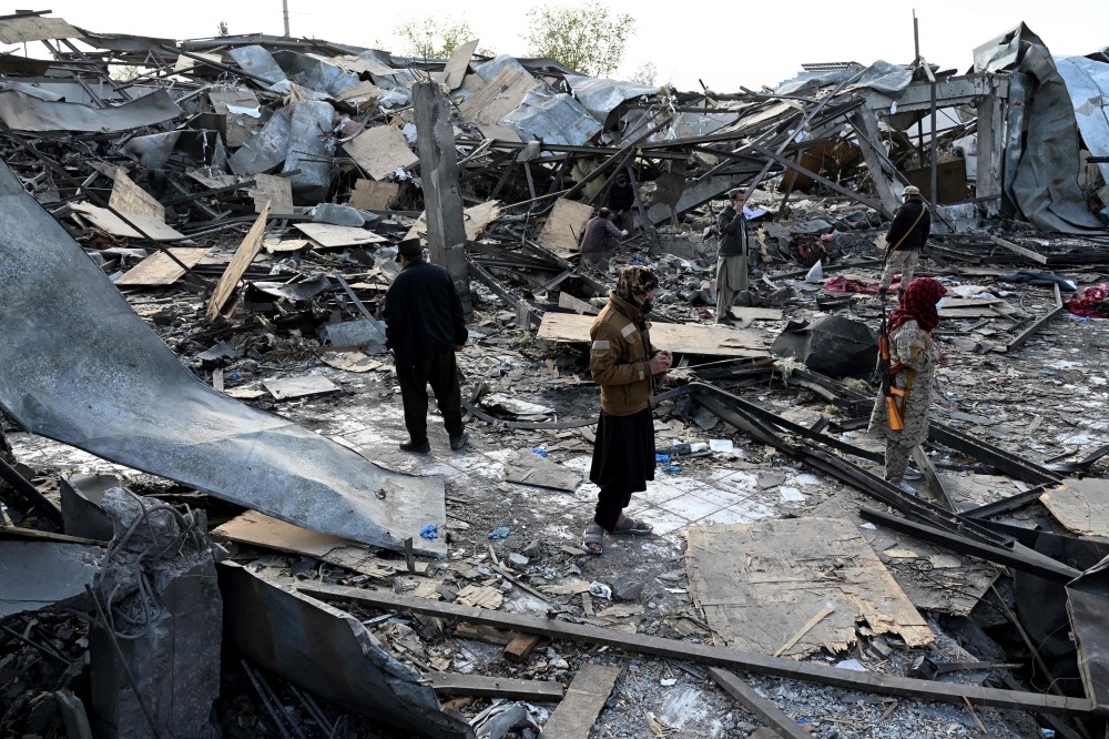 Taliban security personnel inspect the site after Pakistani airstrikes hit the Secondary Rehabilitation Services Centre in Kabul on March 17, 2026. (Photo by Wakil Kohsar / AFP)