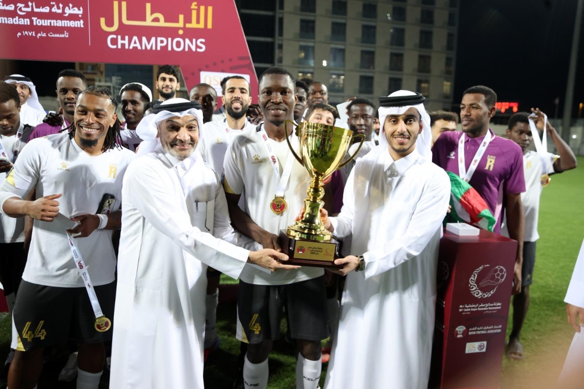 QSL CEO Hani Taleb Ballan presents the winner's trophy to Al Riffa captain.